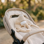 Cradlely bottle holder on a stroller seat in soft daylight
