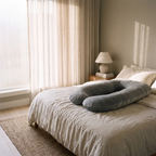 Nessa pregnancy pillow in a bedroom with soft window light